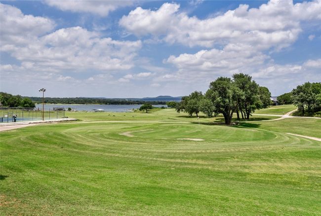 View of community featuring a swimming pool, a lawn, a water view, and golf course view | Image 13