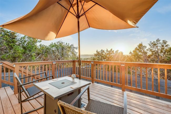 Deck at dusk featuring outdoor dining area | Image 16