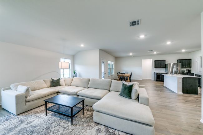 Living room with light wood-type flooring and vaulted ceiling | Image 5