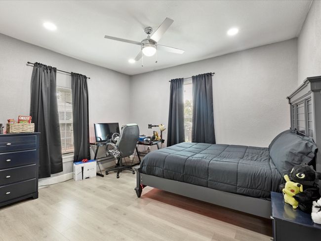Bedroom with light wood-style flooring, ceiling fan, and recessed lighting | Image 26