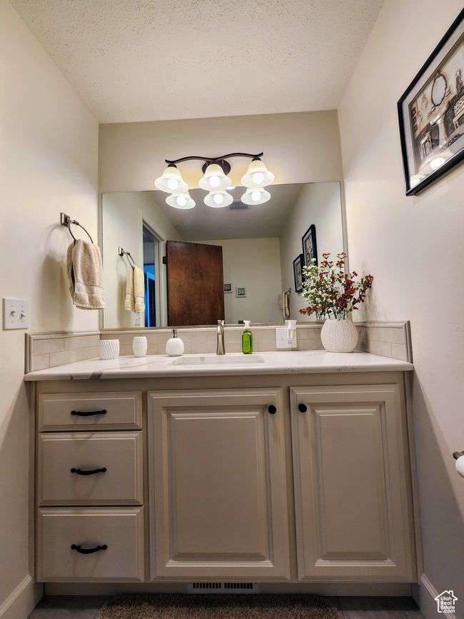 Bathroom featuring vanity, baseboards, and a notable chandelier | Image 23
