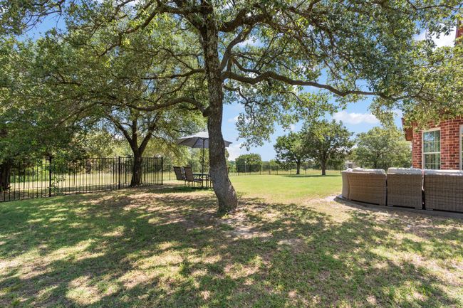 View of yard with wrought iron fence | Image 35