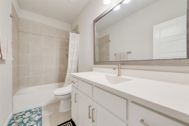 Bathroom featuring toilet, vanity, shower / bath combo, and tile patterned flooring | Image 24