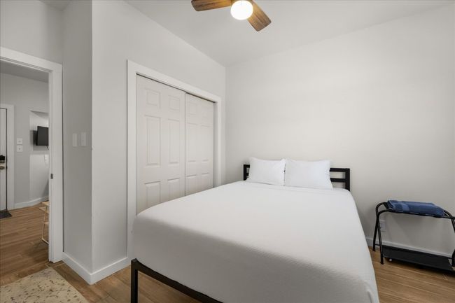 Bedroom featuring a closet, wood finished floors, and ceiling fan | Image 20