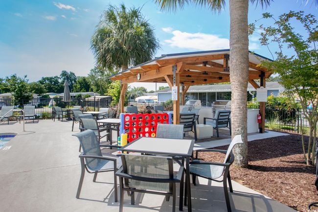 View of patio with an outdoor kitchen, outdoor dining space, and a gazebo | Image 32