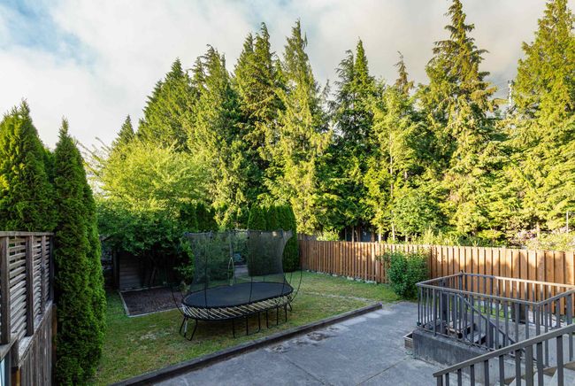Fenced backyard featuring a trampoline, a patio, and stairs | Image 24