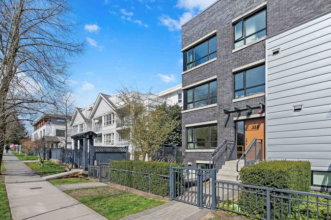 View of building exterior with a residential view and a fenced front yard | Image 29