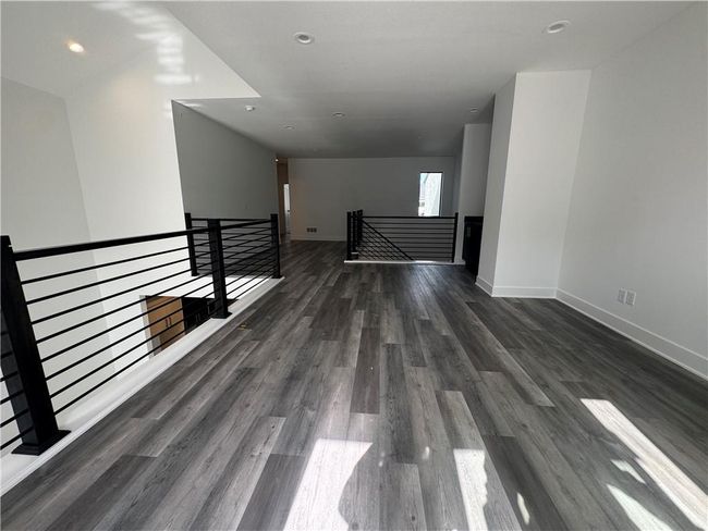 Spare room with baseboards, wood finished floors, and recessed lighting | Image 30