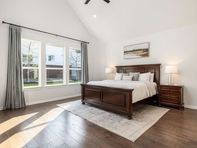 Bedroom with baseboards, a ceiling fan, dark wood-style floors, recessed lighting, and high vaulted ceiling | Image 8