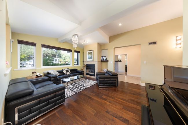 Living room featuring wood finished floors, a fireplace, recessed lighting, beam ceiling, and baseboards | Image 10