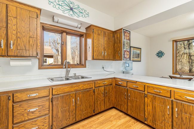Cabinets galore for all your kitchen storage. Dishes aren't a chore with the beautiful view of the wooded lot out the windows. | Image 17