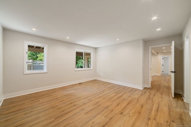 The primary bedroom, located at the end of a hallway, is basically a separate suit of its own, complete with spa-like bath and walk-in closet. | Image 19