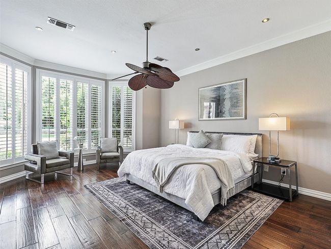 Bedroom with wood-type flooring, crown molding, and recessed lighting | Image 23