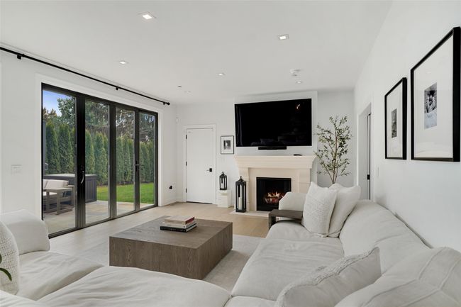 Living area with recessed lighting, light wood-style | Image 16
