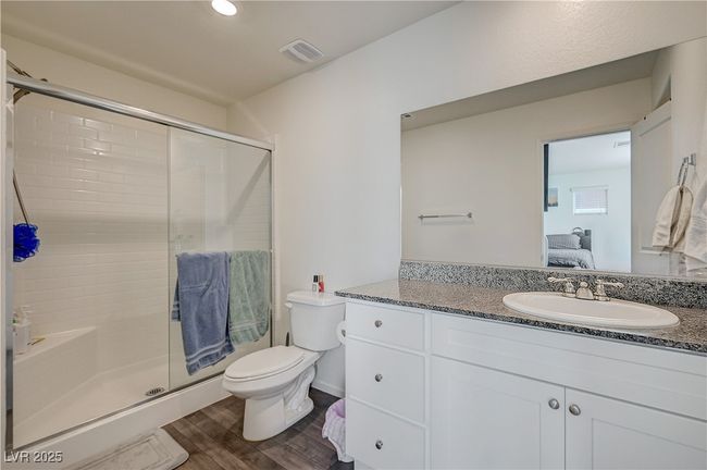 Ensuite bathroom featuring vanity, a shower stall, and wood finished floors | Image 17