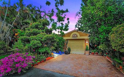 Nestled on one of the widest culdesac in former "model row", this former model cottage-style home is enchanting from begnning to end! | Image 1