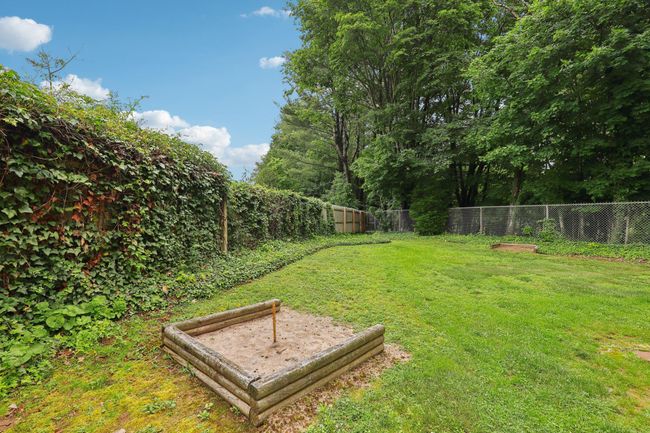 View of grassy yard featuring stairway and an outdoor fire pit | Image 34