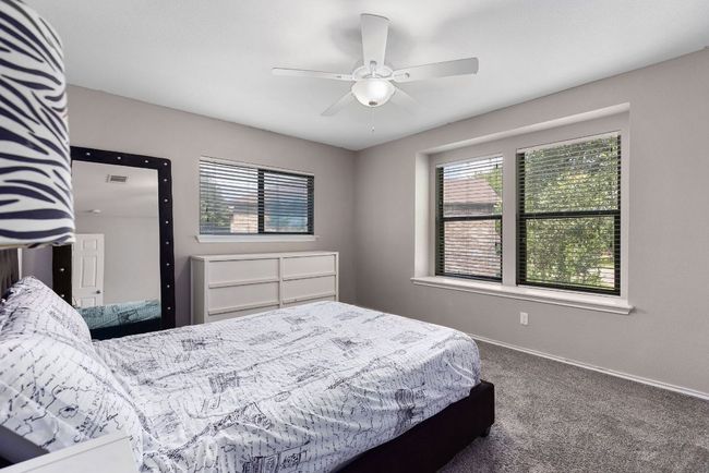 Carpeted bedroom featuring baseboards and a ceiling fan | Image 32