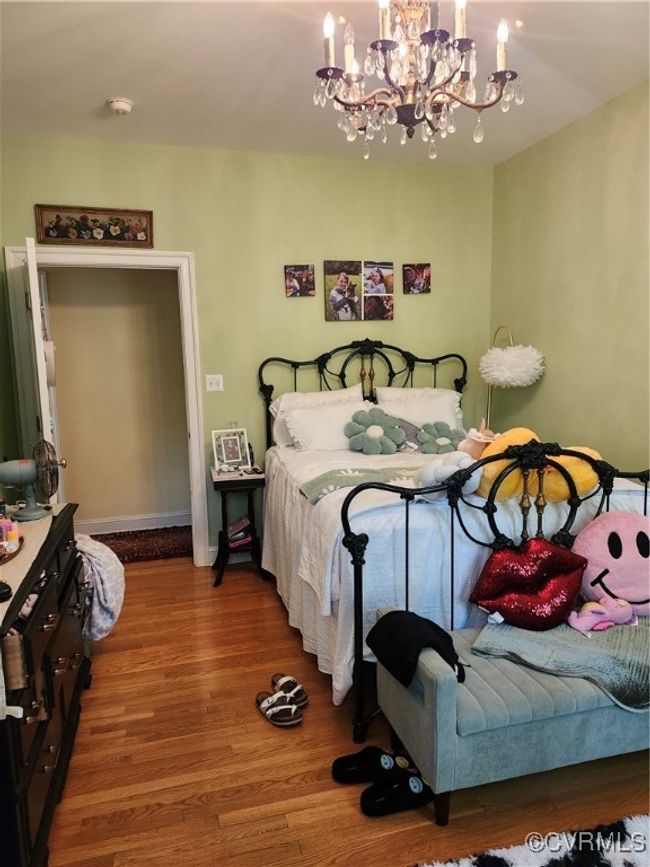 2nd Bedroom featuring wood finished floors, baseboards, and an inviting chandelier | Image 17