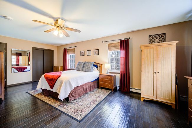 Primary bedroom with remarkable dark wood-style floors, and a ceiling fan | Image 18