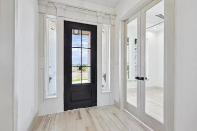 Entryway with light hardwood / wood-style flooring and french doors | Image 3