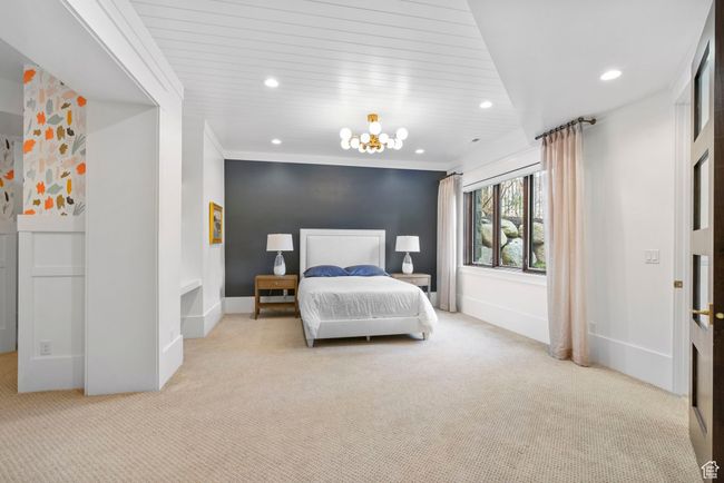 Bedroom with baseboards, an inviting chandelier, ornamental molding, recessed lighting, and carpet flooring | Image 75