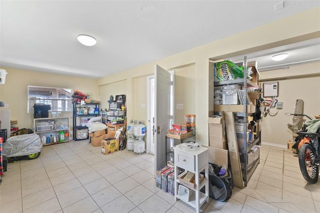 Spacious multipurpose/storage downstairs with tiled floors and ample storage. Ideal for storage and workspace. Many owners have cut out a roll up door and created a Tiki Experience! | Image 8