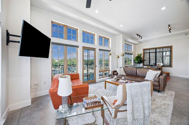 Living area with concrete flooring, recessed lighting, and ceiling fan | Image 5