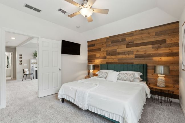 Bedroom featuring wooden walls, carpet floors, and ceiling fan | Image 26