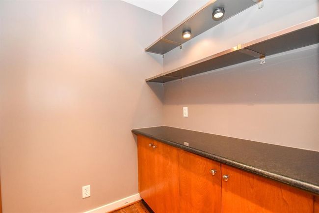 Stylish dry bar area with a sleek countertop, ideal for entertaining. | Image 21