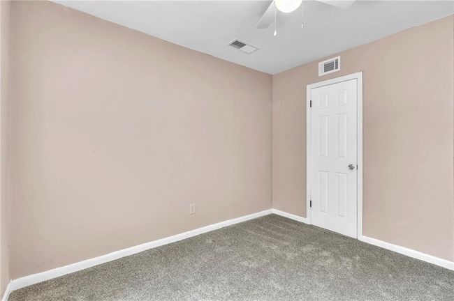 Unfurnished room featuring carpet, visible vents, a ceiling fan, and baseboards | Image 29