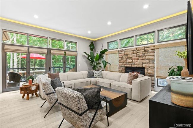 Family room with stone fireplace. | Image 16