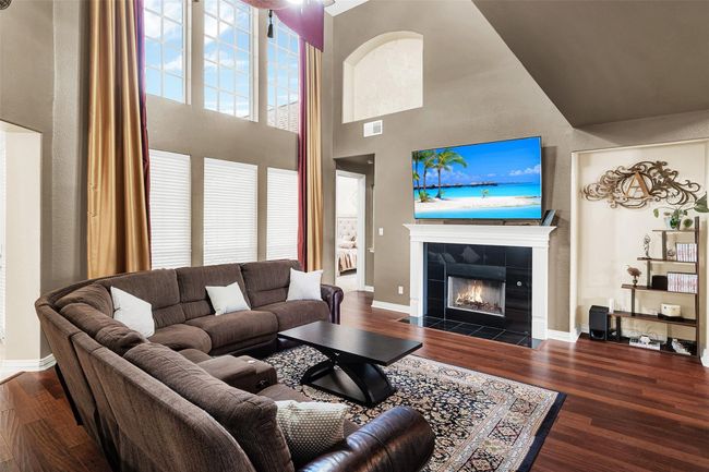 Main living area features fireplace and wall of windows to the pretty backyard | Image 14