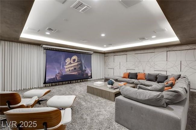 Cinema room featuring visible vents, carpet floors, and a tray ceiling | Image 29