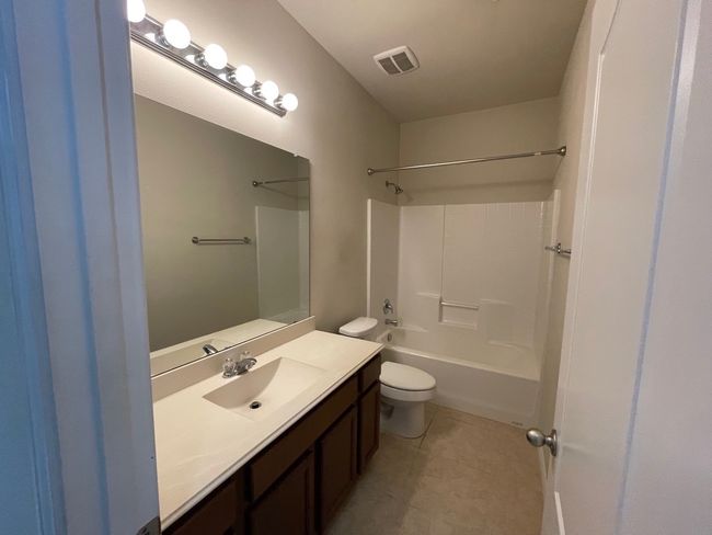 Full bath with vanity, bathing tub / shower combination, and tile patterned flooring | Image 20