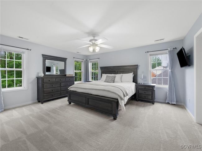 Bedroom featuring light colored carpet and ceiling fan | Image 17