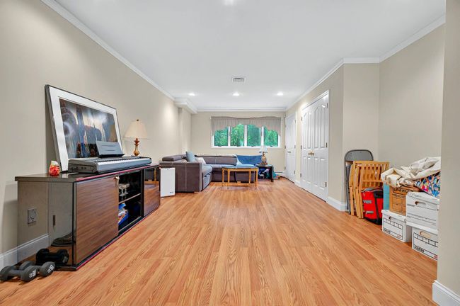 Office space with light wood-style flooring, ornamental molding, baseboards, and recessed lighting | Image 40