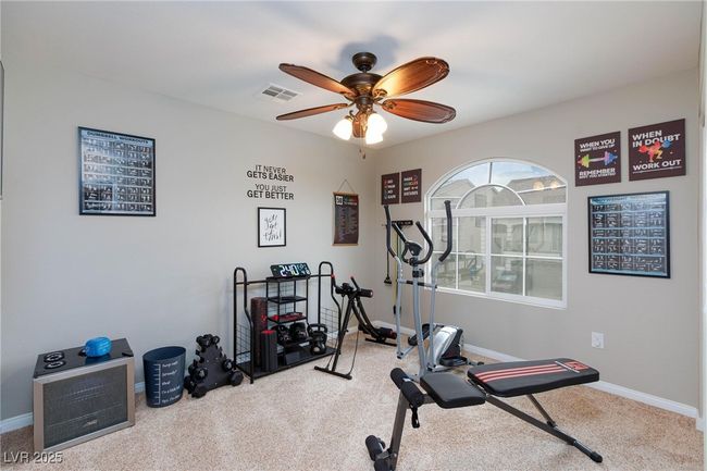 Exercise area with baseboards, a ceiling fan, visible vents, and carpet flooring | Image 35