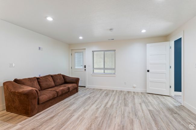 Living area featuring baseboards, visible vents, light wood finished floors, and recessed lighting | Image 30