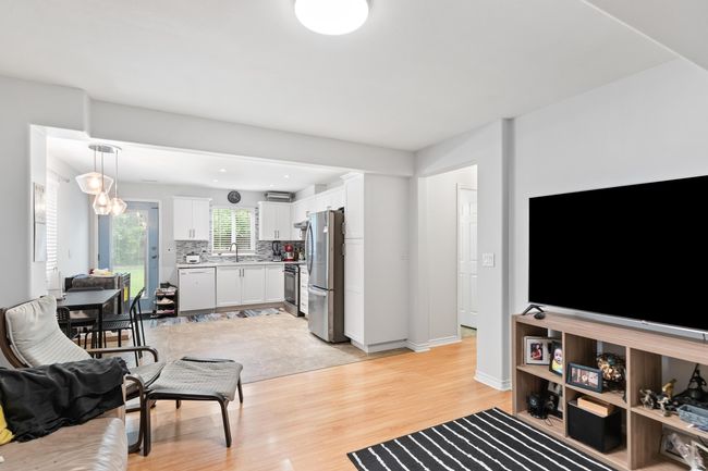 Living room with light wood-style floors and baseboards | Image 24