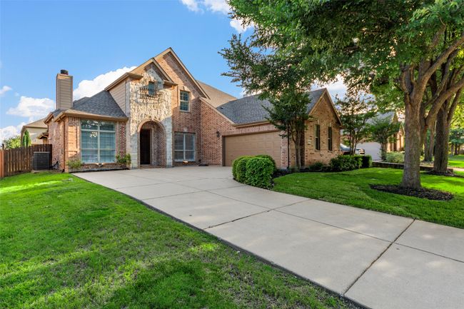 View of front of house with brick siding, driveway, a chimney, an attached garage, and a shingled roof | Image 6