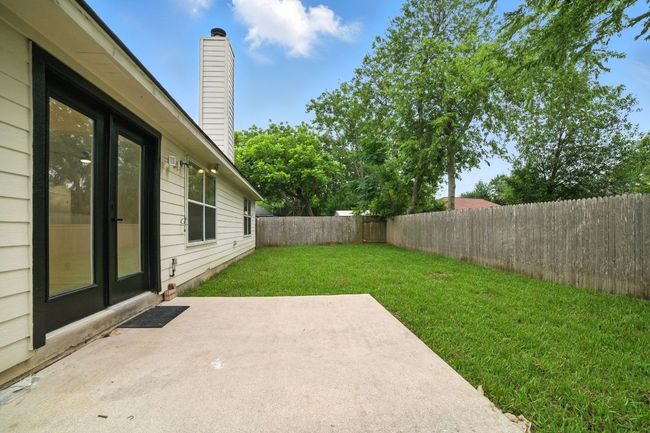 Step outside to a private backyard oasis with a concrete patio, new sod, and a full wood privacy fence—ideal for relaxing or entertaining outdoors. | Image 27