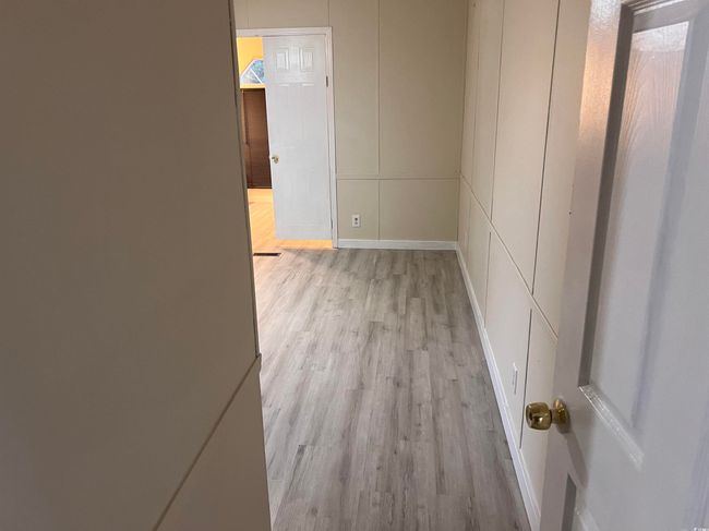 Unfurnished bedroom featuring light wood-style floors, ornamental molding, ensuite bath, baseboards, and ceiling fan | Image 21