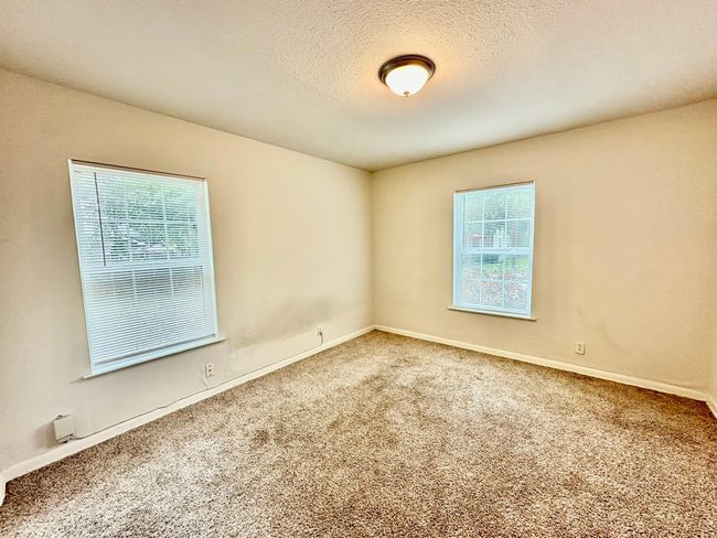 Carpeted spare room featuring baseboards and a textured ceiling | Image 9