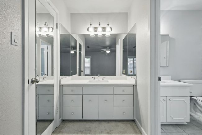 Bathroom featuring two vanities, a ceiling fan, and a sink | Image 24
