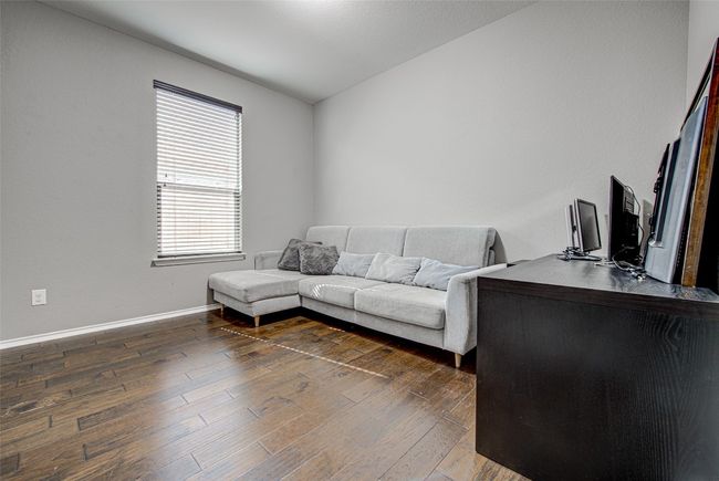 Living area with baseboards and dark wood-style floors | Image 15