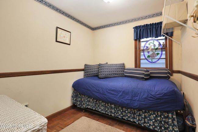 Bedroom on main level has Parquet wood floors. | Image 21