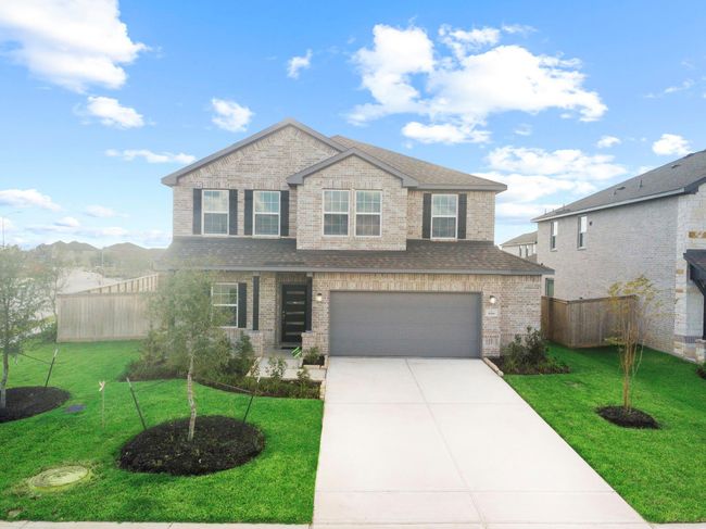 Front exterior view showcasing the home’s all-brick design, landscaped entry, and welcoming curb appeal that stands out beautifully within the community. | Image 38