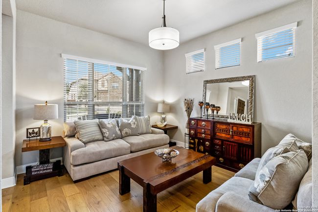 A bright and inviting living room with large windo | Image 7