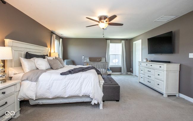 bedroom with light colored carpet and a ceiling fan | Image 5